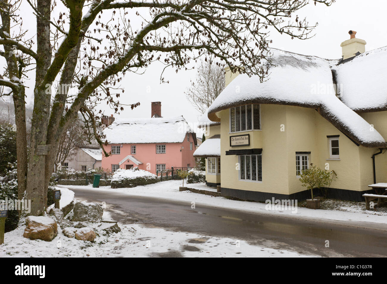 Couvert de neige pub et cottages dans le village de Winsford, Parc National d'Exmoor, Somerset, Angleterre. Banque D'Images