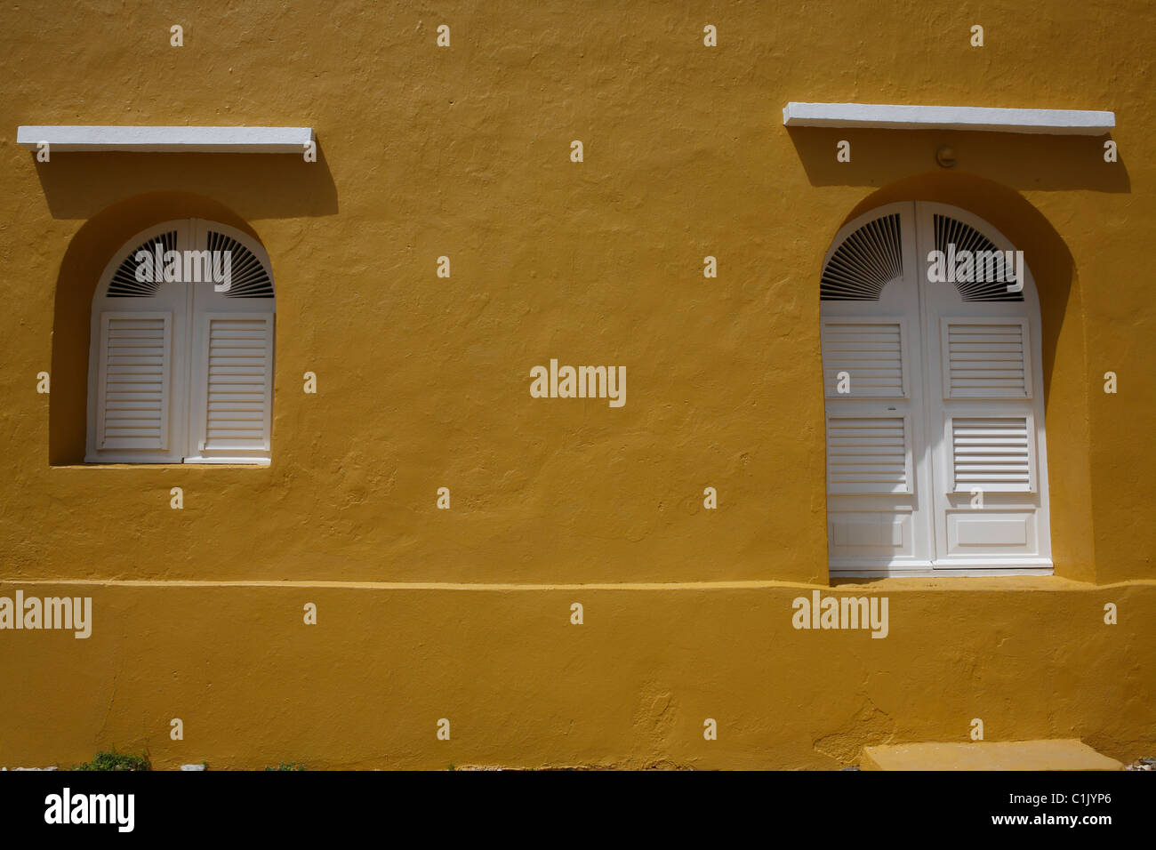 White windows sur un bâtiment jaune au Parc National Washington-Slagbaai à Bonaire, Antilles néerlandaises. Banque D'Images