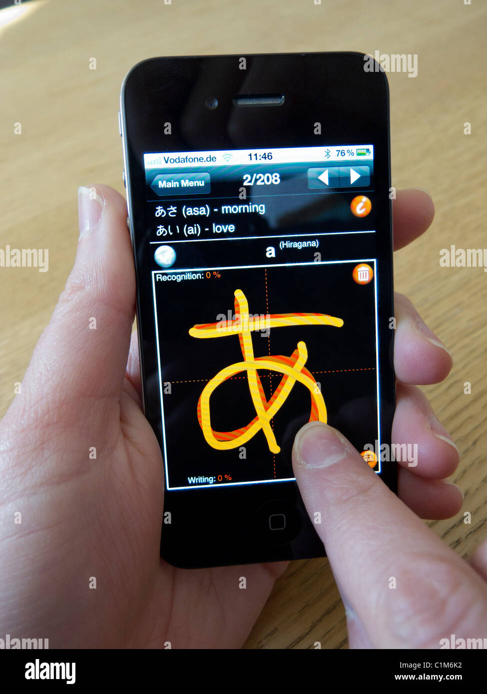 L'apprentissage des élèves d'écrire les caractères japonais à l'aide de l'app sur un Apple Iphone 4G Téléphone intelligent Banque D'Images