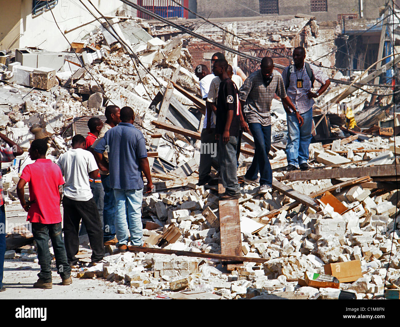 Les gens de marcher dans les ruines de Port-au-Prince après le séisme en Haïti Banque D'Images