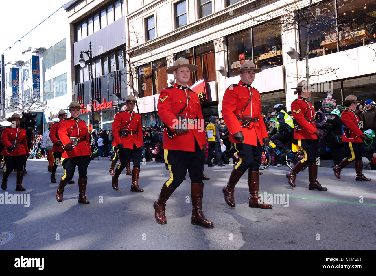 La police montée canadienne marcher sur la rue Sainte-Catherine à Montréal pendant la parade de la St Patrick. Banque D'Images