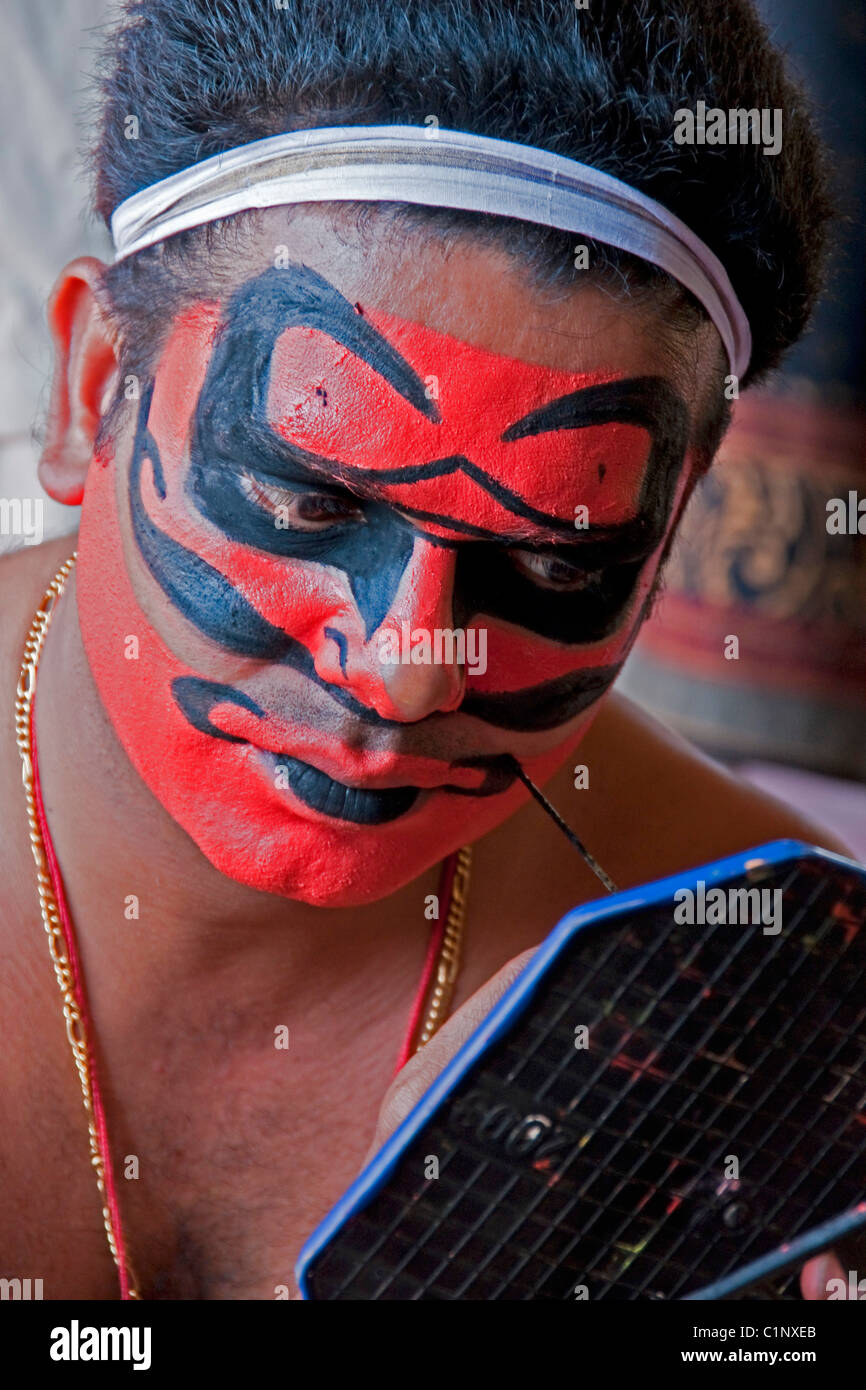 Artiste Kathakali traditionnel appliquant le maquillage avant l'exécution dans l'état du Kerala. Banque D'Images