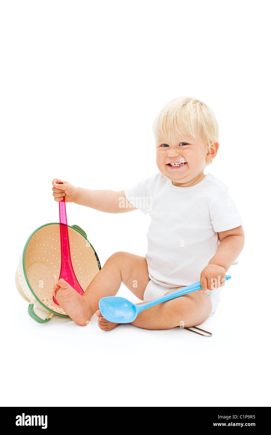 Studio shot of baby boy playing with ladle Banque D'Images