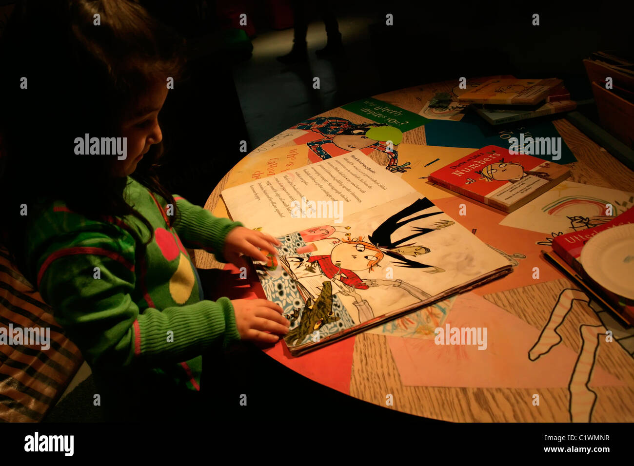 Enfant de trois ans à la recherche de l'enfant à Lauren Qui a peur du grand méchant livre à la découverte Story Centre, London, UK Banque D'Images