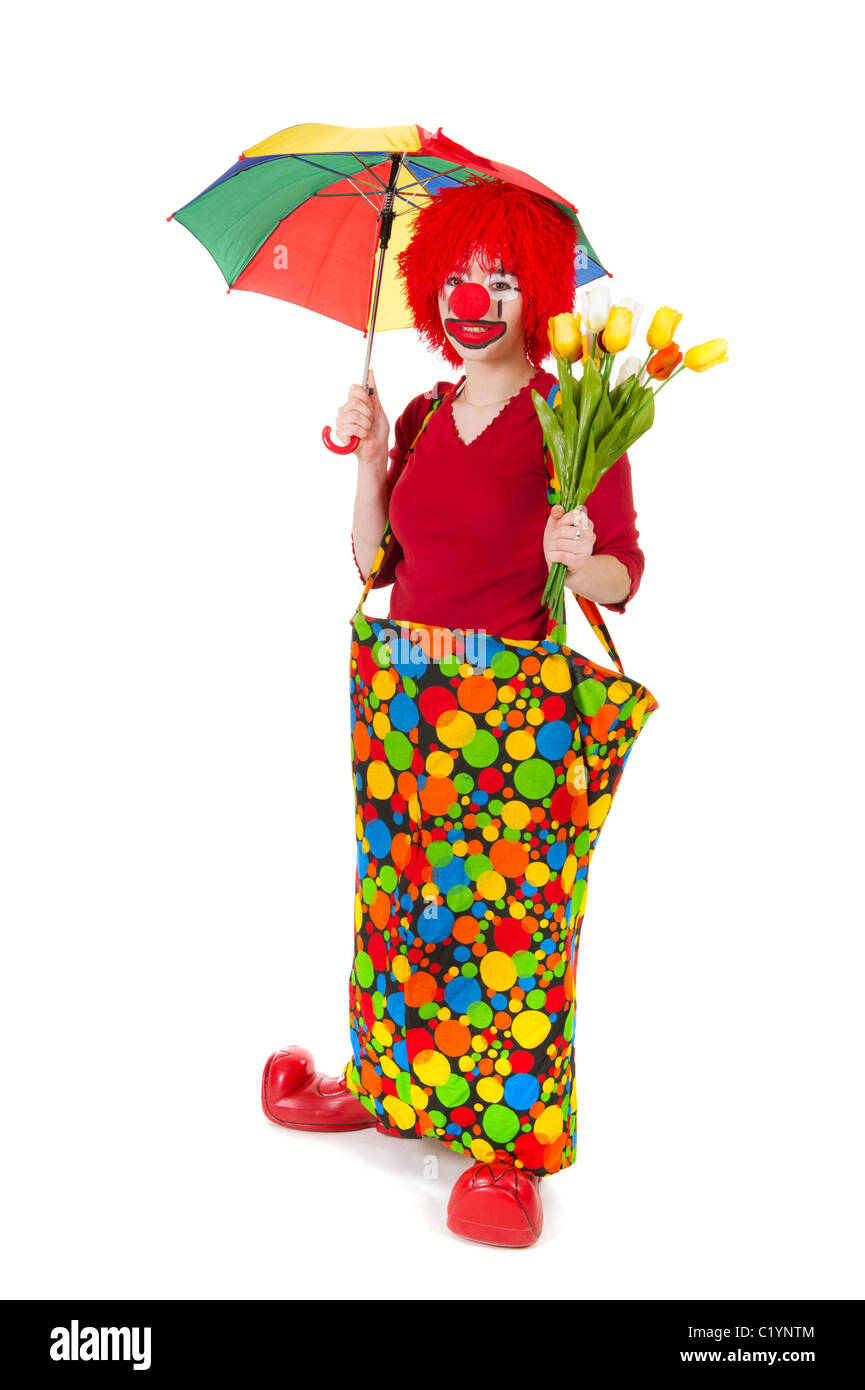 Funny clown avec fleurs et parapluie dans le studio Banque D'Images