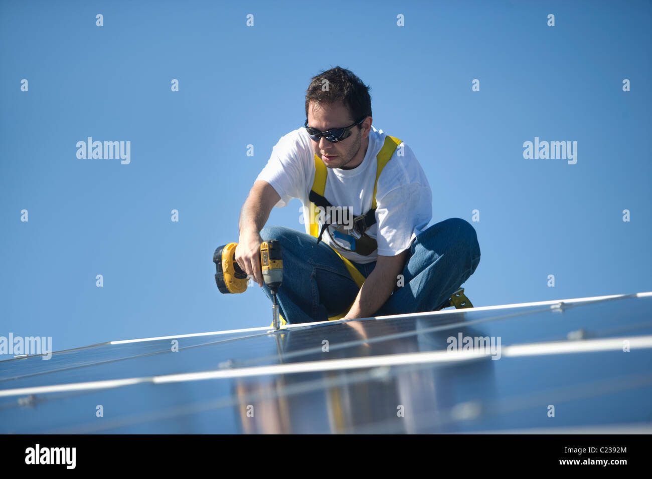 Un homme travaillant sur panneaux solaires Banque D'Images