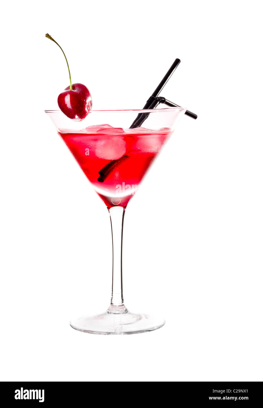 Verre rouge en verre à martini, garnie de cerise marachino. Isolé sur fond blanc. Banque D'Images