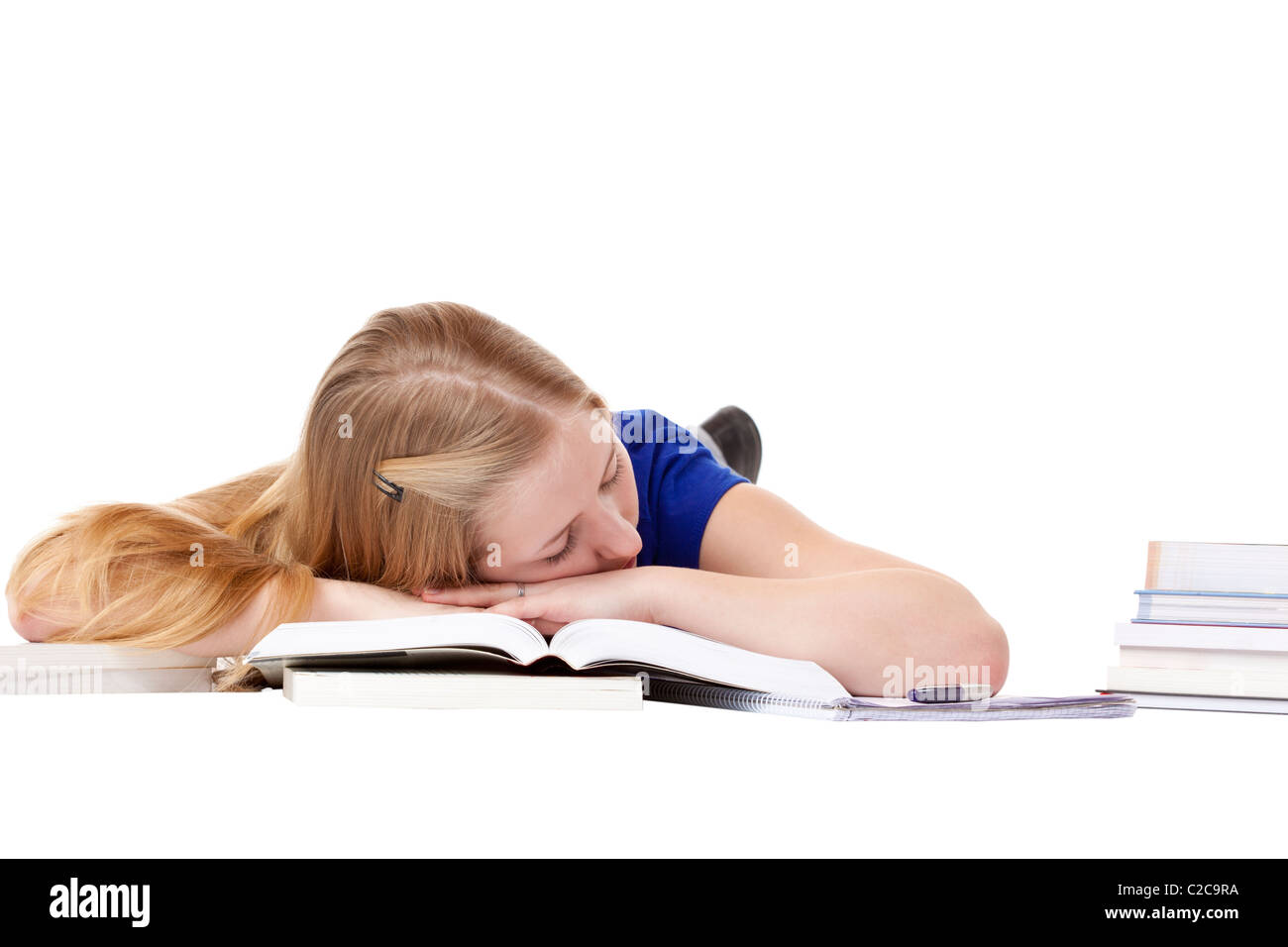 Young attractive female student sleeping at livres sur l'étage. Isolé sur fond blanc. Banque D'Images