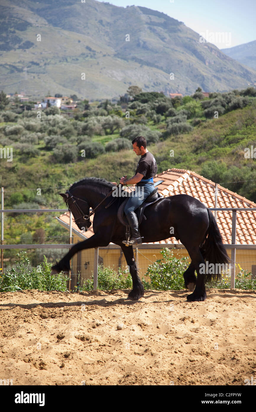 Un cavalier met son cheval à l'épreuve dans les montagnes au-dessus de Palerme Sicile Banque D'Images