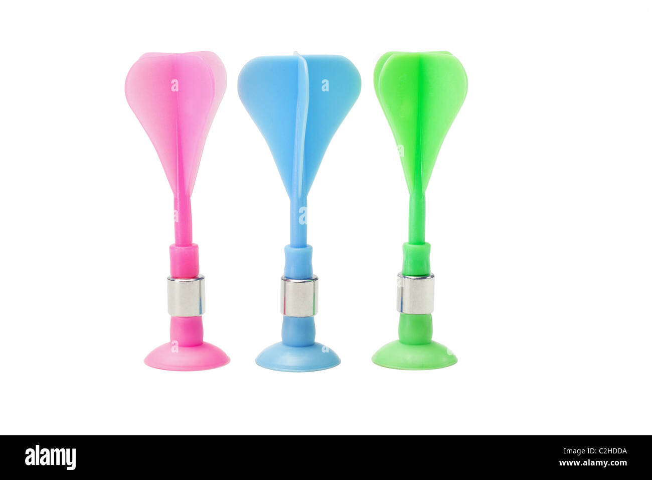 Jouet en plastique multicolore fléchettes standing in a row on white background Banque D'Images
