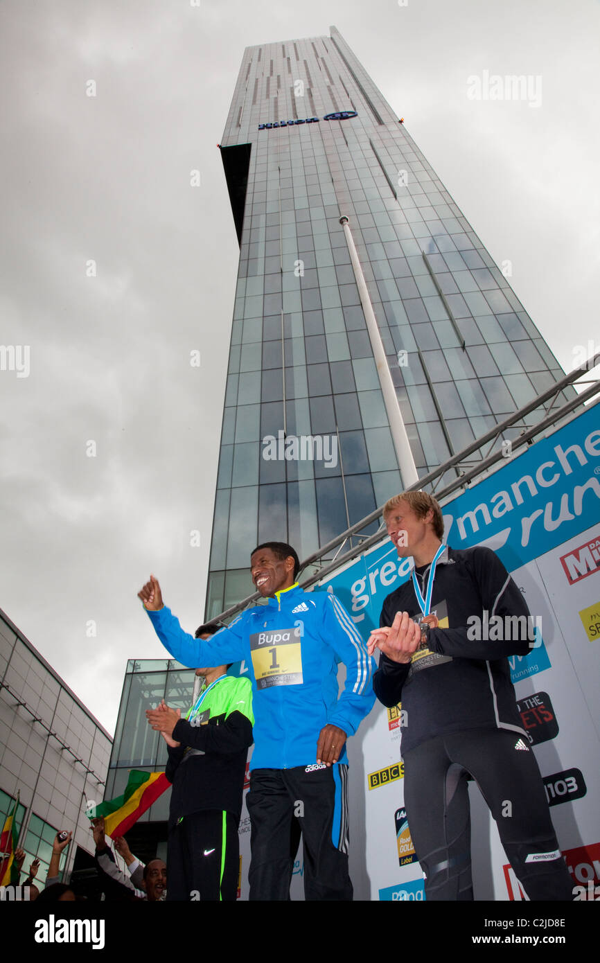 Haile Gebrselassie, célèbre comme il est présenté avec sa médaille après avoir remporté le 10 km de Manchester en 2010 Banque D'Images