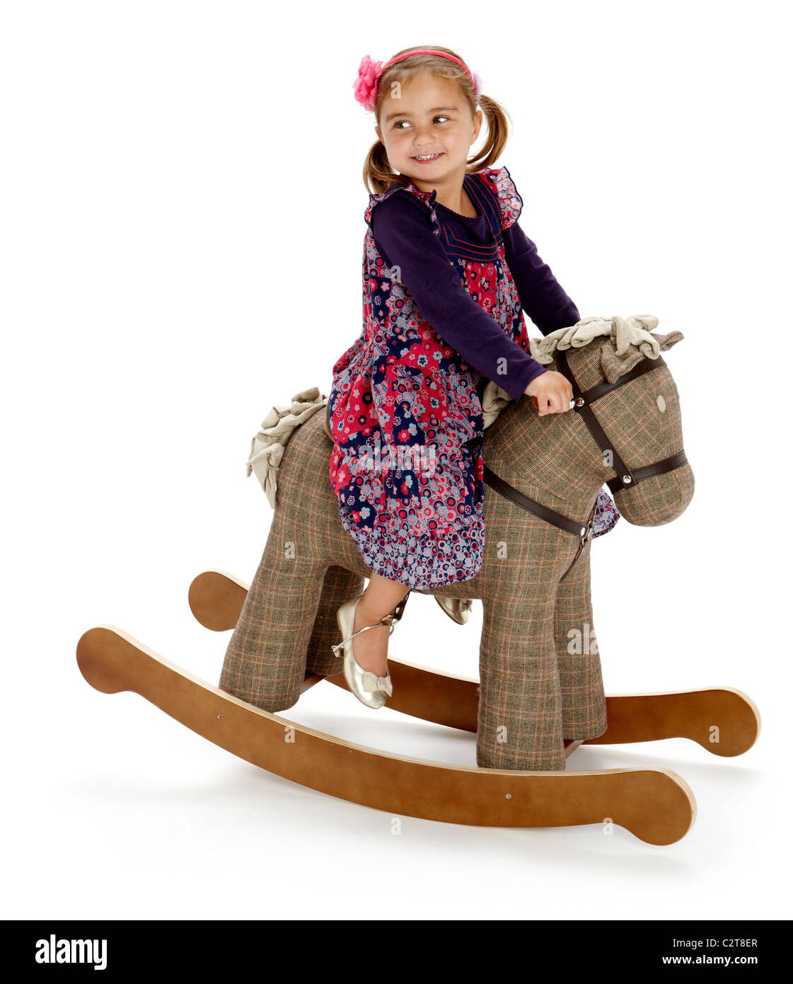 Petite fille jouant à bascule cheval poney rocker Banque D'Images