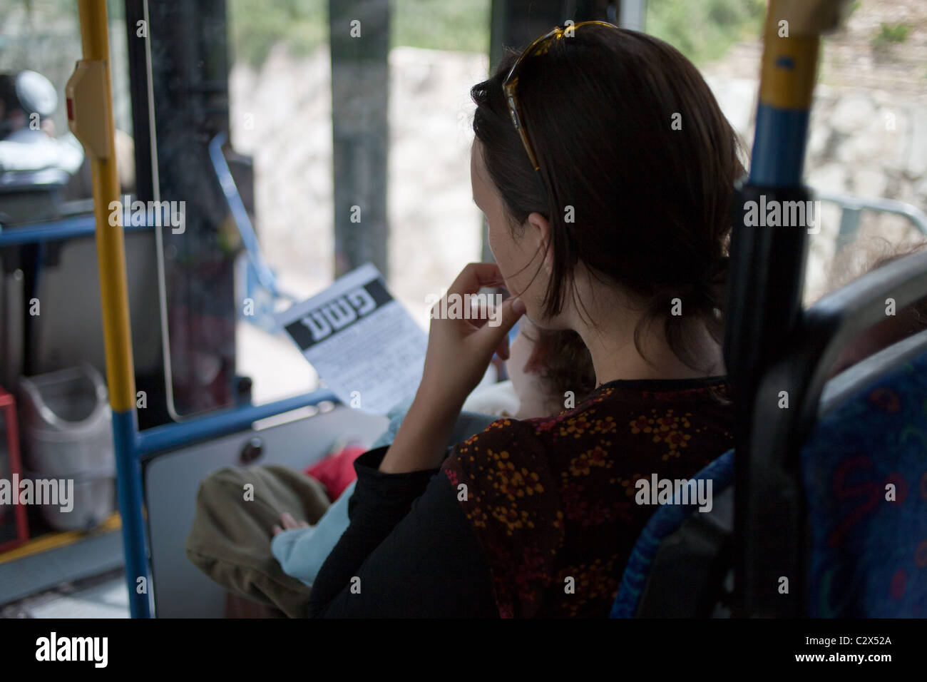 Une femme religieuse lit tract distribué par des militants anti-ségrégation alors qu'il était assis à l'arrière du bus distincts. Banque D'Images