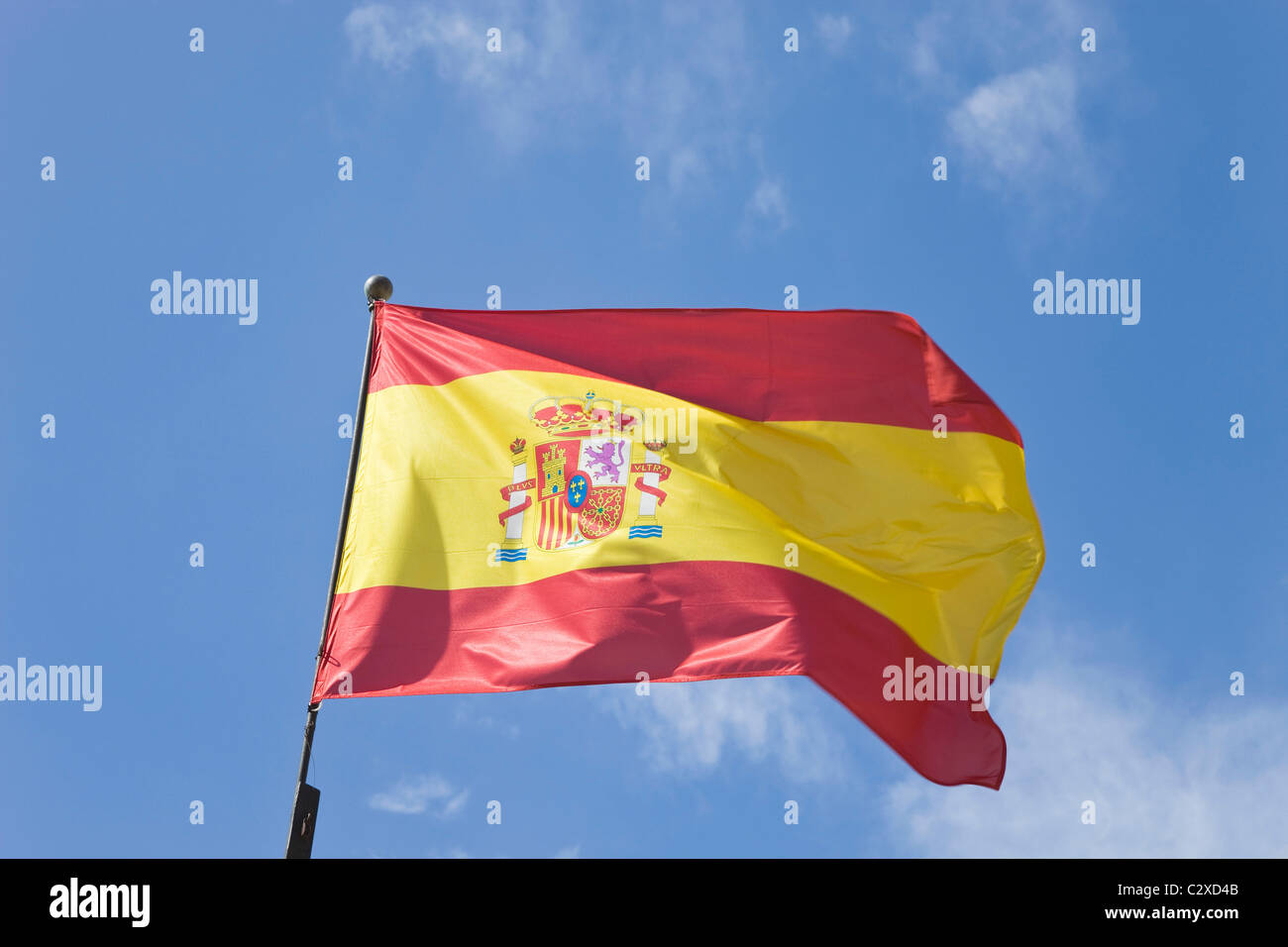Oubliez le drapeau espagnol dans la brise contre un ciel bleu Banque D'Images