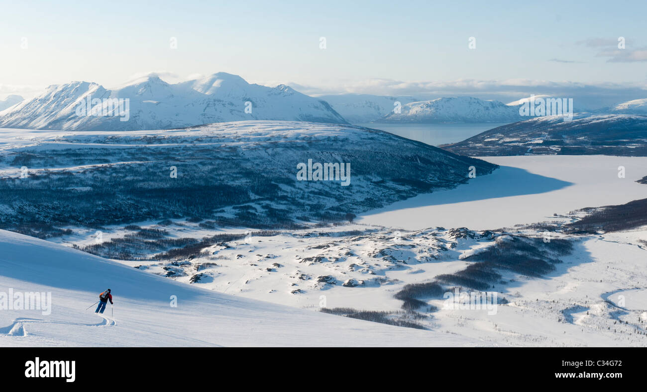 Ski skieur libre vers le bas d'une montagne en hiver le paysage de montagne de Lyngen, la Norvège. Banque D'Images