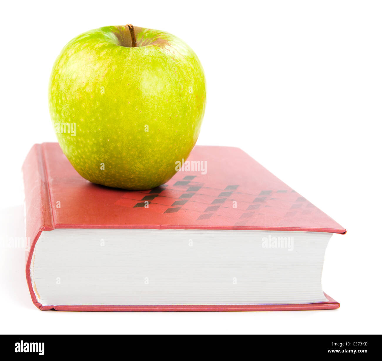 Une pomme verte sur un livre Banque D'Images