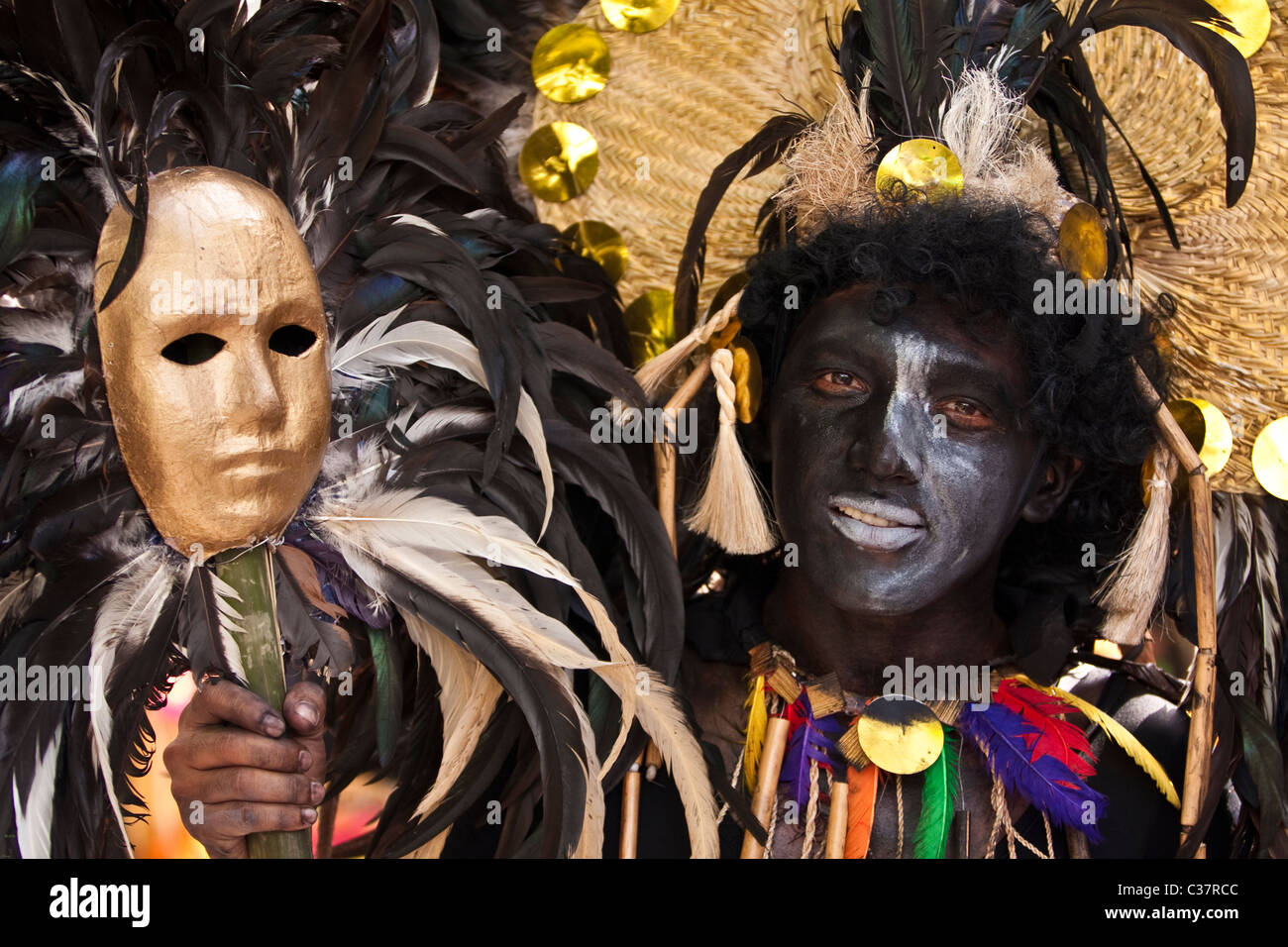 Un visage noir peint avec un danseur de rue masque supplémentaire. Banque D'Images