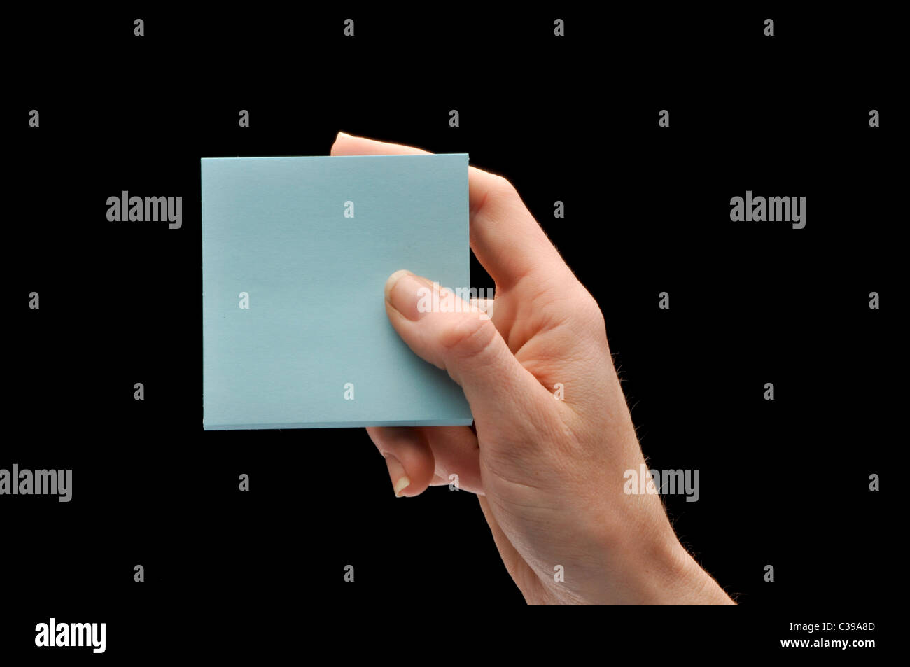 Hand holding blue note pad Banque D'Images Hand holding blue note pad Banque D'Images