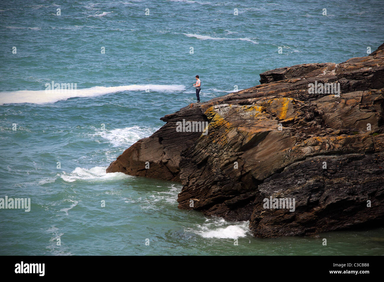Un homme pêche sur Barras Nez falaise à Cornwall England UK English Heritage Banque D'Images
