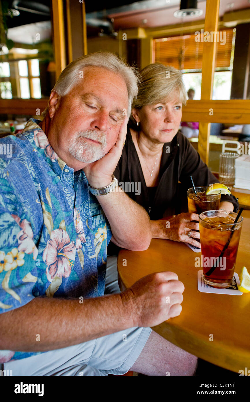 Un couple d'âge moyen semblait indifférent à l'ensemble plus de thés ensemble dans un Long Beach, CA, restaurant. MODEL Banque D'Images