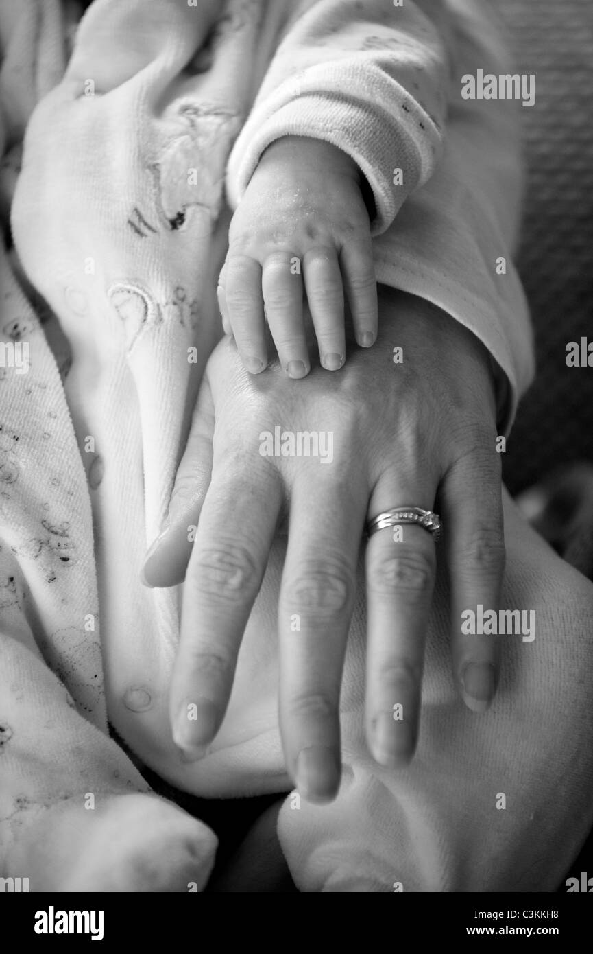 Bébé nouveau-né avec la main à côté de la mère Banque D'Images