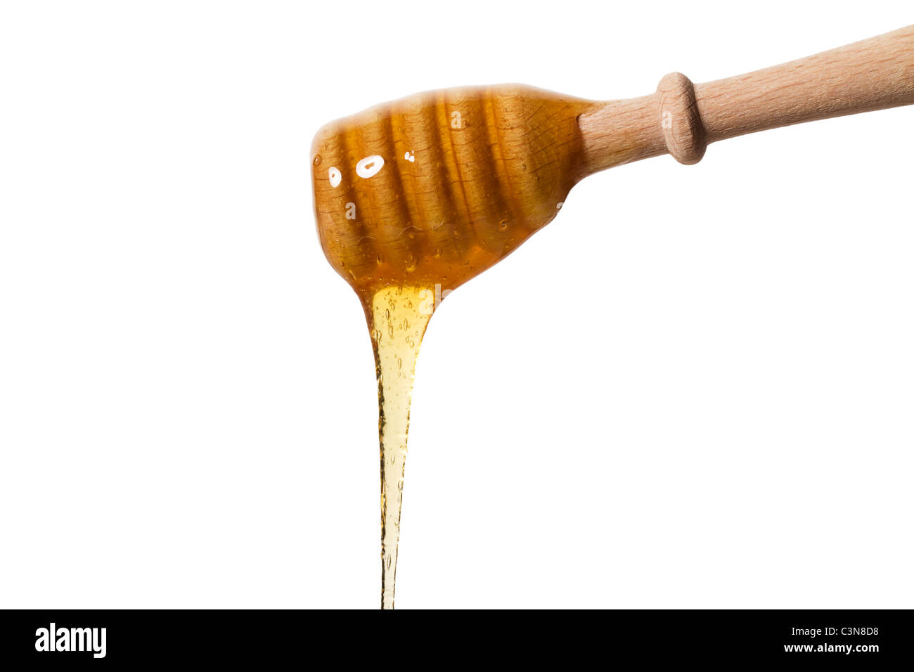 Le miel Le miel la chute d'un balancier sur fond blanc Banque D'Images