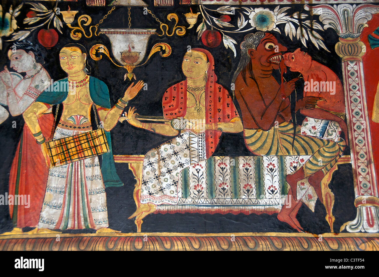 'Musique' tandis que l'homme mange démon murale bouddhiste Chambre Basse Mulkirigala Cave Temple près de Tangalla du sud du Sri Lanka Banque D'Images