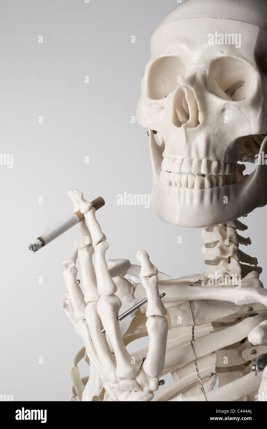 Un squelette de fumer une cigarette Photo Stock - Alamy