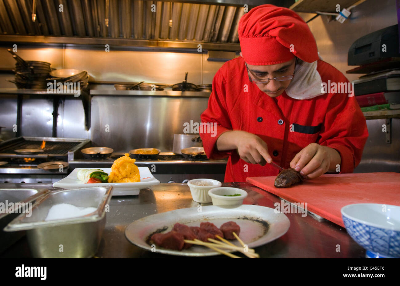 Un chef prépare un steak de kangourou dans un restaurant de New York après une interdiction de servir la viande a été levée. Banque D'Images