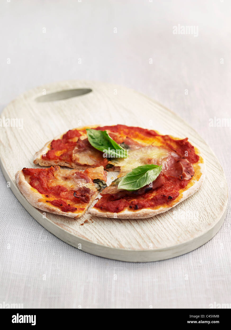 Pizza jambon de Parme sur planche, close-up Banque D'Images