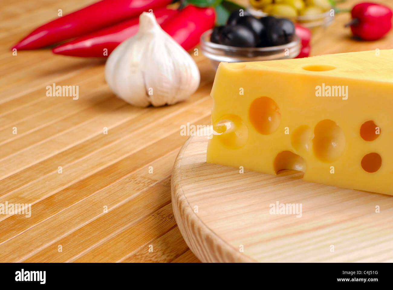 Fromage Emmental ou maasdam avec des légumes sur la table Banque D'Images