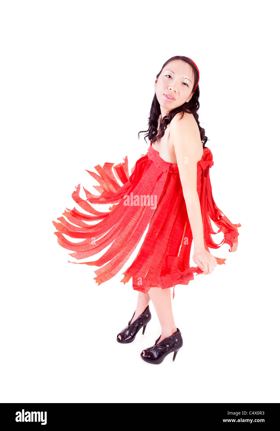 Girl in red paper streamers dress Banque D'Images