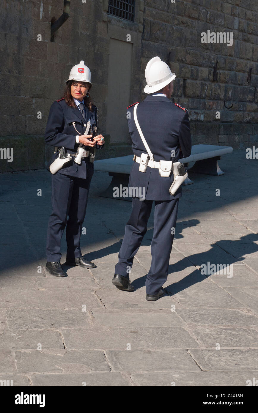 Une femelle et un mâle agent de police patrouillent la Piazza della Signoria à Florence, Italie à pied habillés en uniforme avec un casque. Banque D'Images