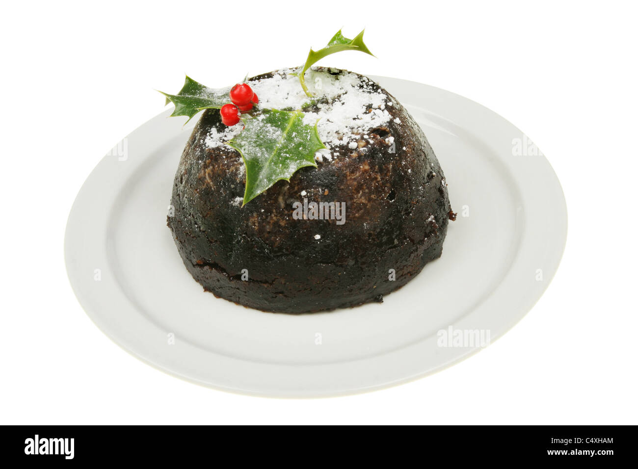Le pudding de Noël décoré sur une plaque Banque D'Images