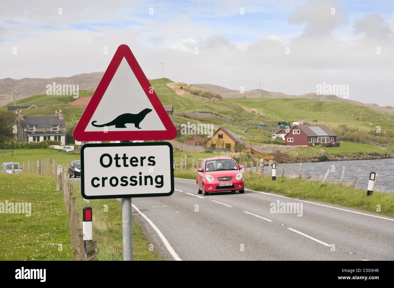 Signe de la route sur un passage à loutres avertissement Scottish route principale près d'un loch de mer sur l'autre. Blancheur, îles Shetland, Écosse, Royaume-Uni, Angleterre Banque D'Images