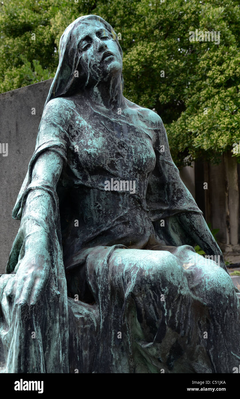 La figure d'une femme en deuil par Mme Didsbury est assise sur la tombe de son fils, Robert, au cimetière de Montmartre. Banque D'Images