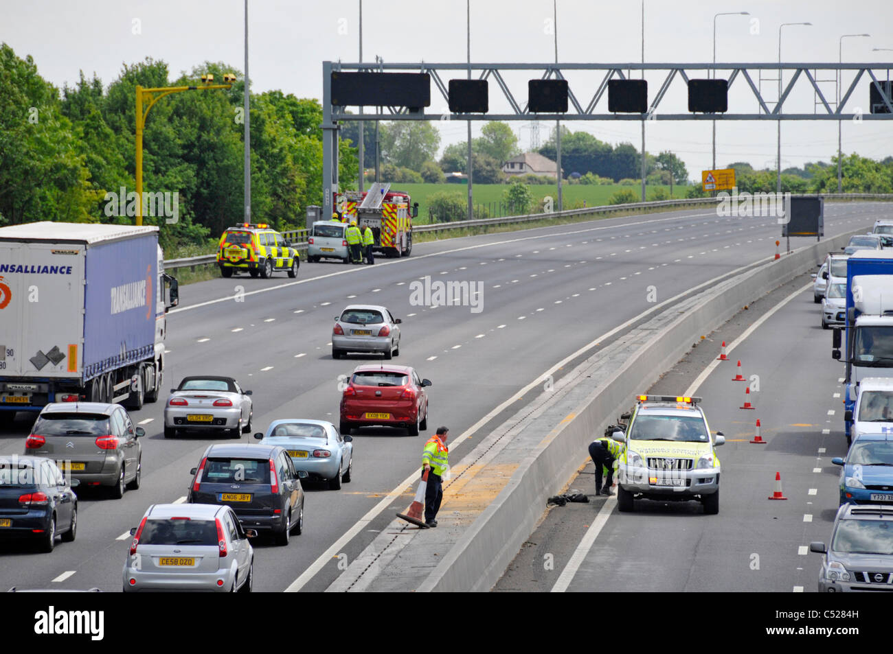 Deux équipes de la Voirie publique les agents de circulation éclaircir après deux accidents accident de voiture sur chaque autoroute M25 4 voies lentes et les véhicules à l'arrêt UK Banque D'Images