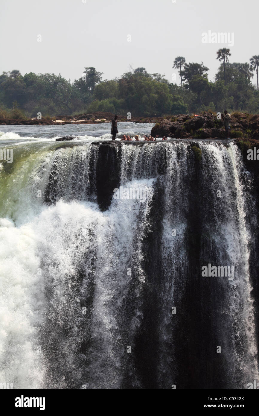 Les touristes se baignent dans le Devil's Pool au Victoria Falls, à la frontière entre la Zambie et le Zimbabwe. Banque D'Images