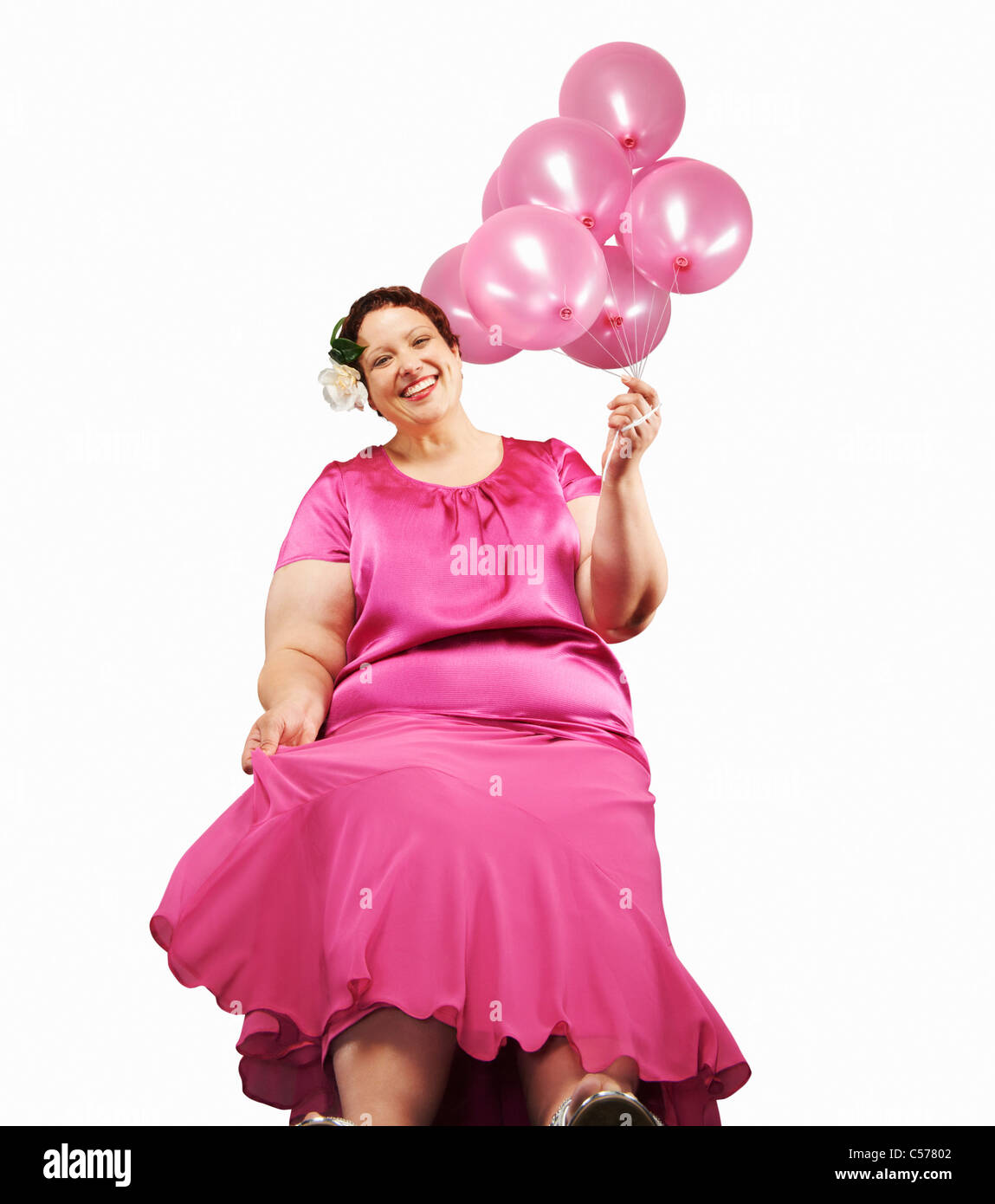 Grand woman holding bunch of balloons Banque D'Images