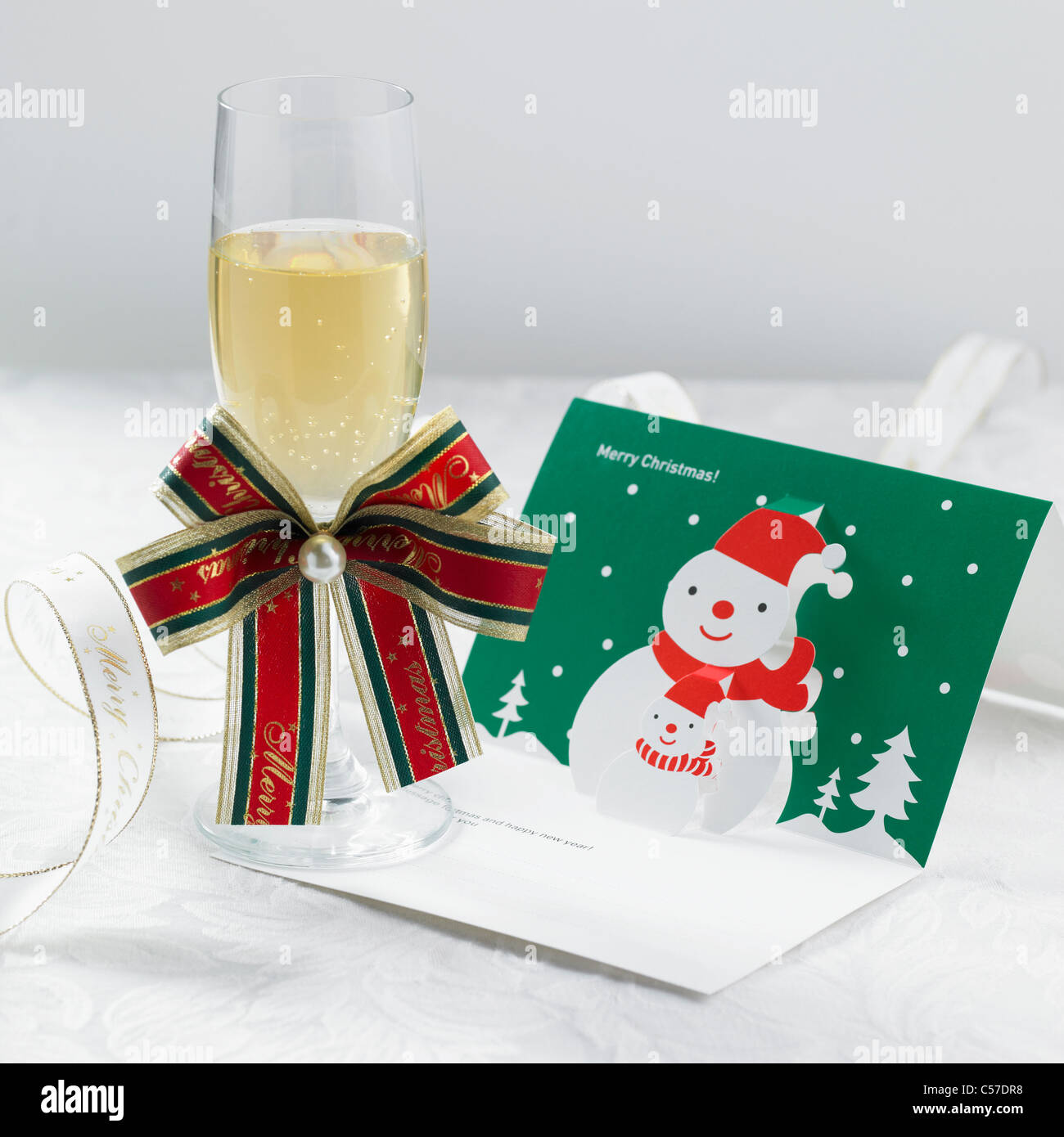 Le verre à champagne et carte de Noël Banque D'Images
