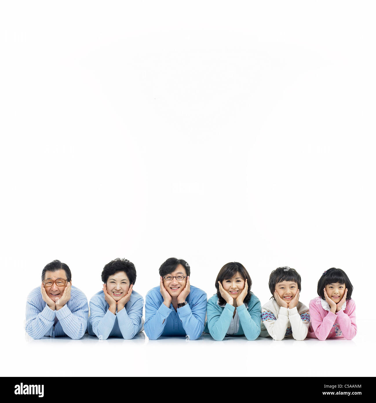 Portrait of family lying on floor Banque D'Images