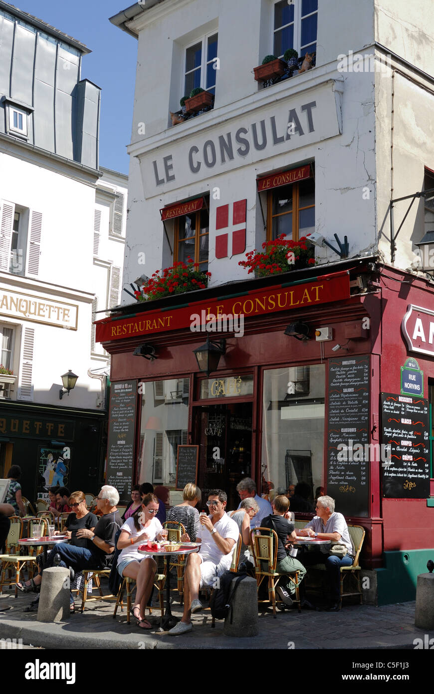 Des gens assis en plein air au café Le Consulat Rue Norvins dans le quartier populaire de Montmartre, Paris France Banque D'Images