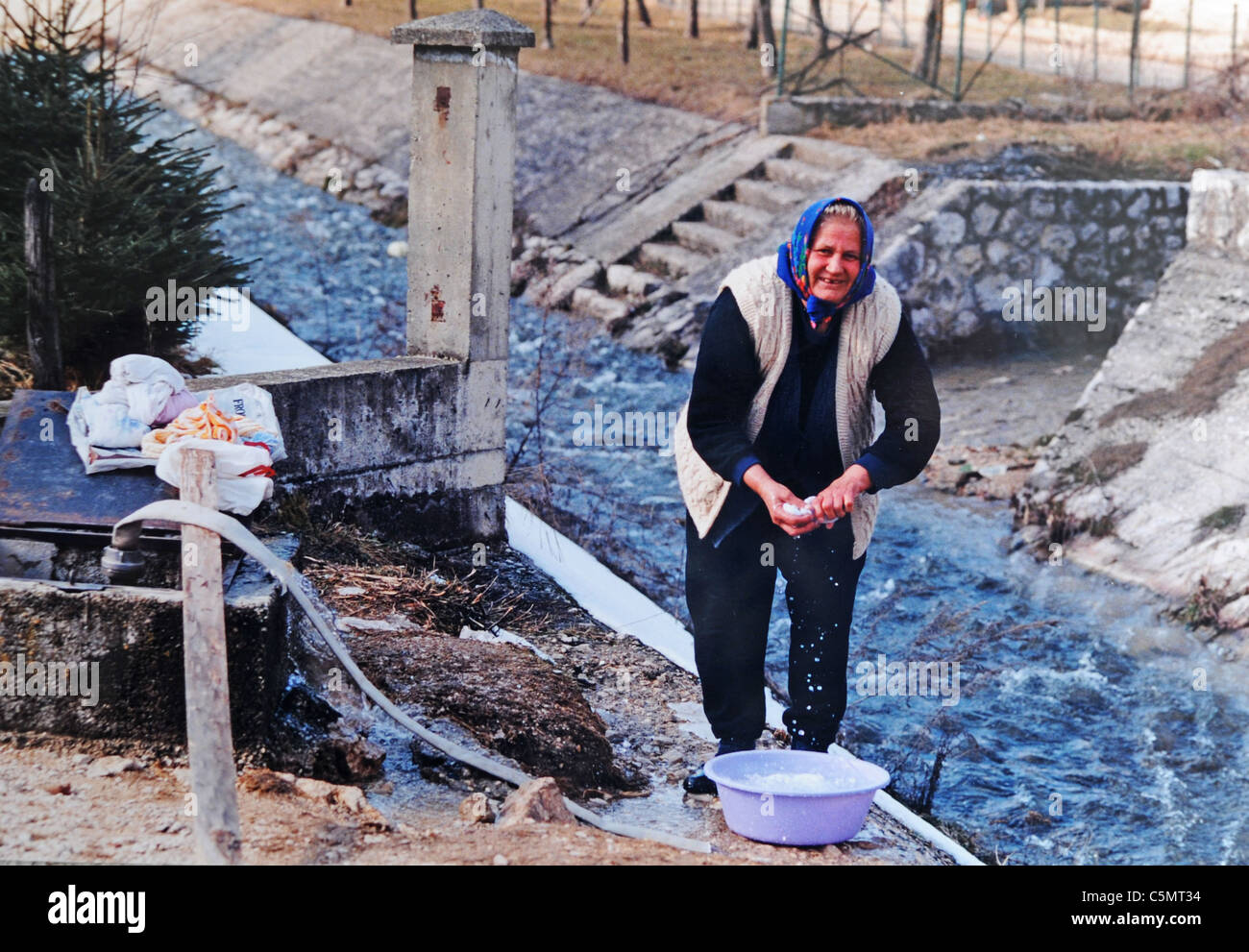 Une femme essaie de revenir à la vie normale ici, se lavant des vêtements dans une rivière voisine après être rentrée à son bombardé à la maison à Mrkonjic Grad Bosnie Europe Banque D'Images