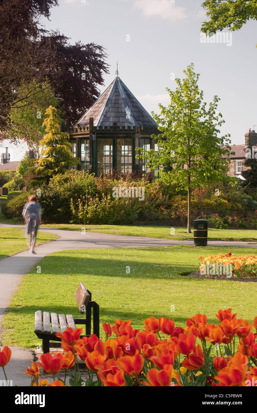 Magnifique parc de village paysagé, parterres colorés, pelouse soignée, belvédère historique (Round House) et personne - Grange Park Burley-in-Wharfedale, Angleterre Banque D'Images