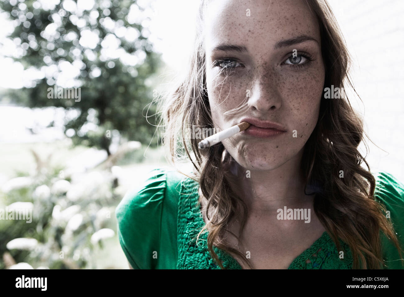 Allemagne, Berlin, young woman smoking cigarette, portrait, close-up Banque D'Images