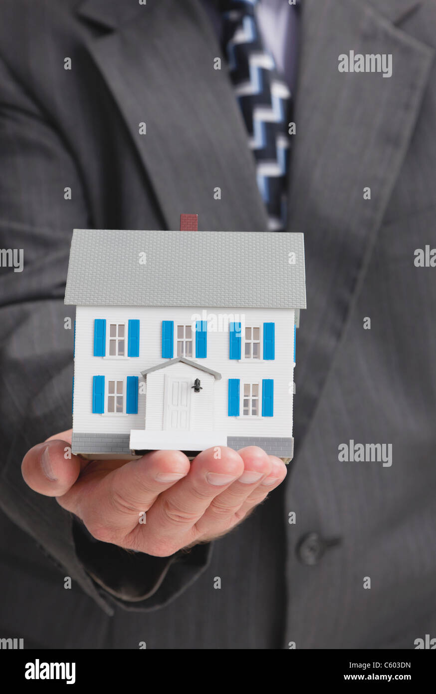 Close up of man's hand holding model house Banque D'Images