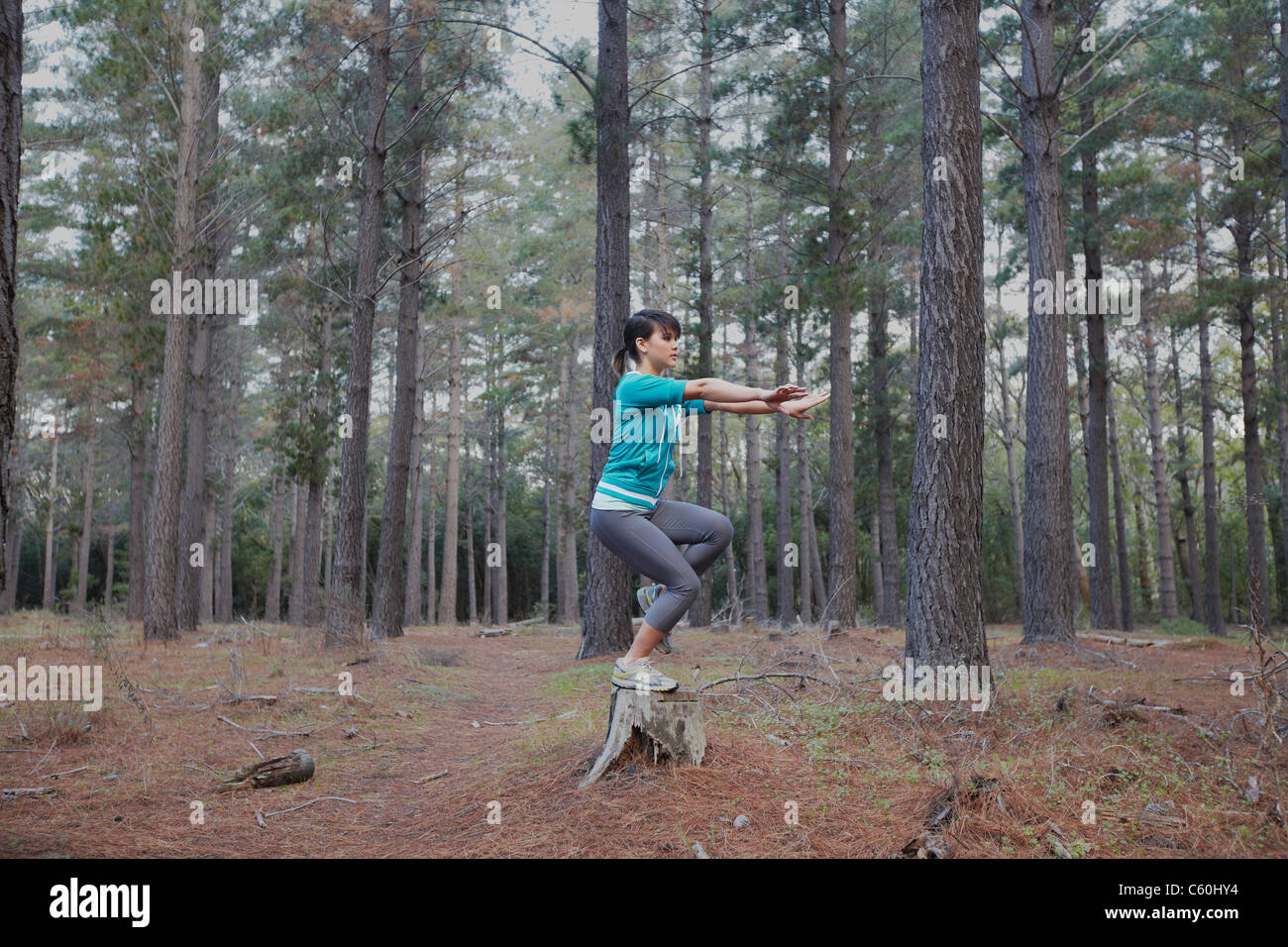Woman balancing sur moignon en forêt Banque D'Images Woman balancing sur moignon en forêt Banque D'Images