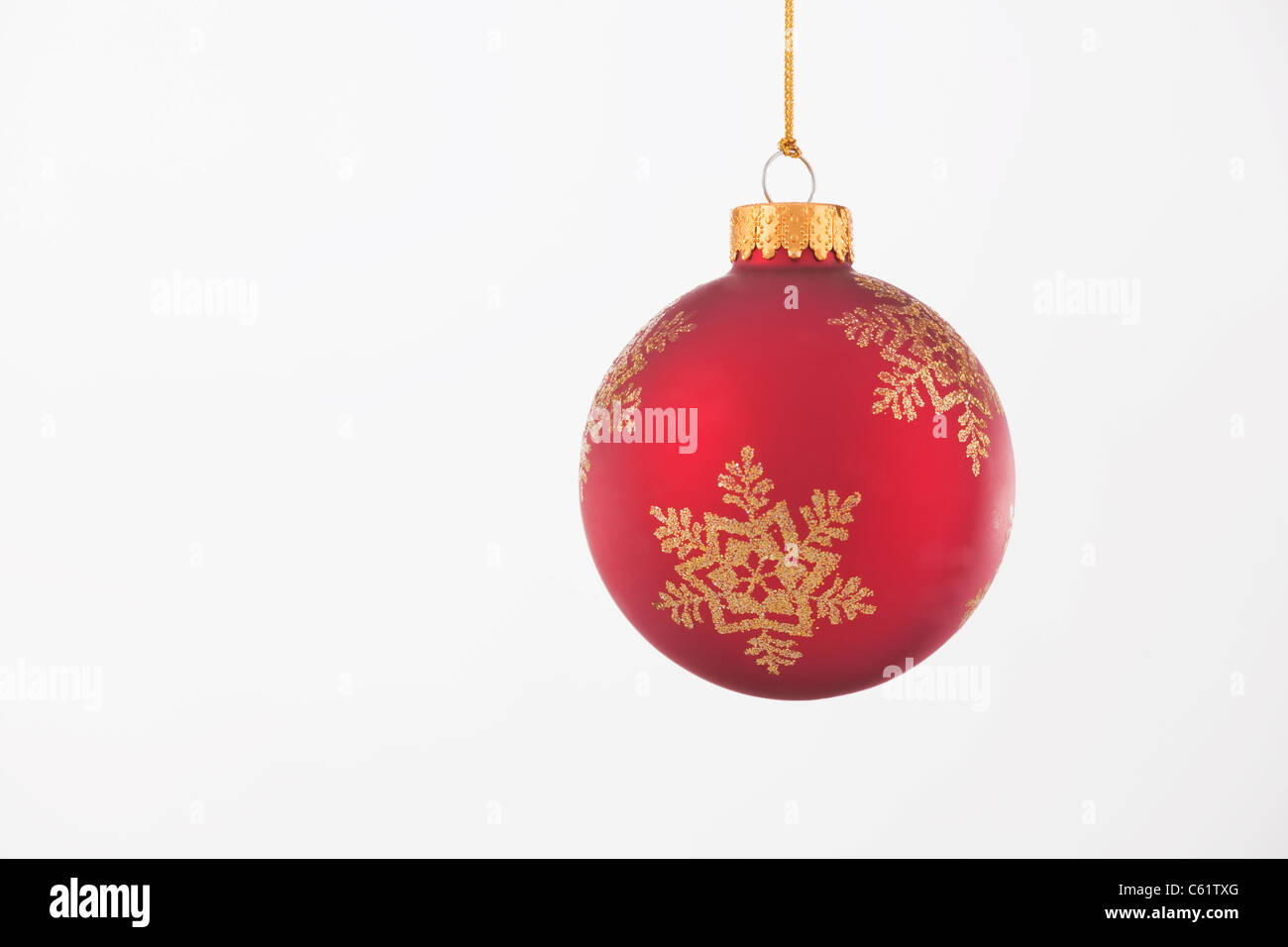 Un ornement de Noël rouge et or isolé sur un fond blanc. Banque D'Images