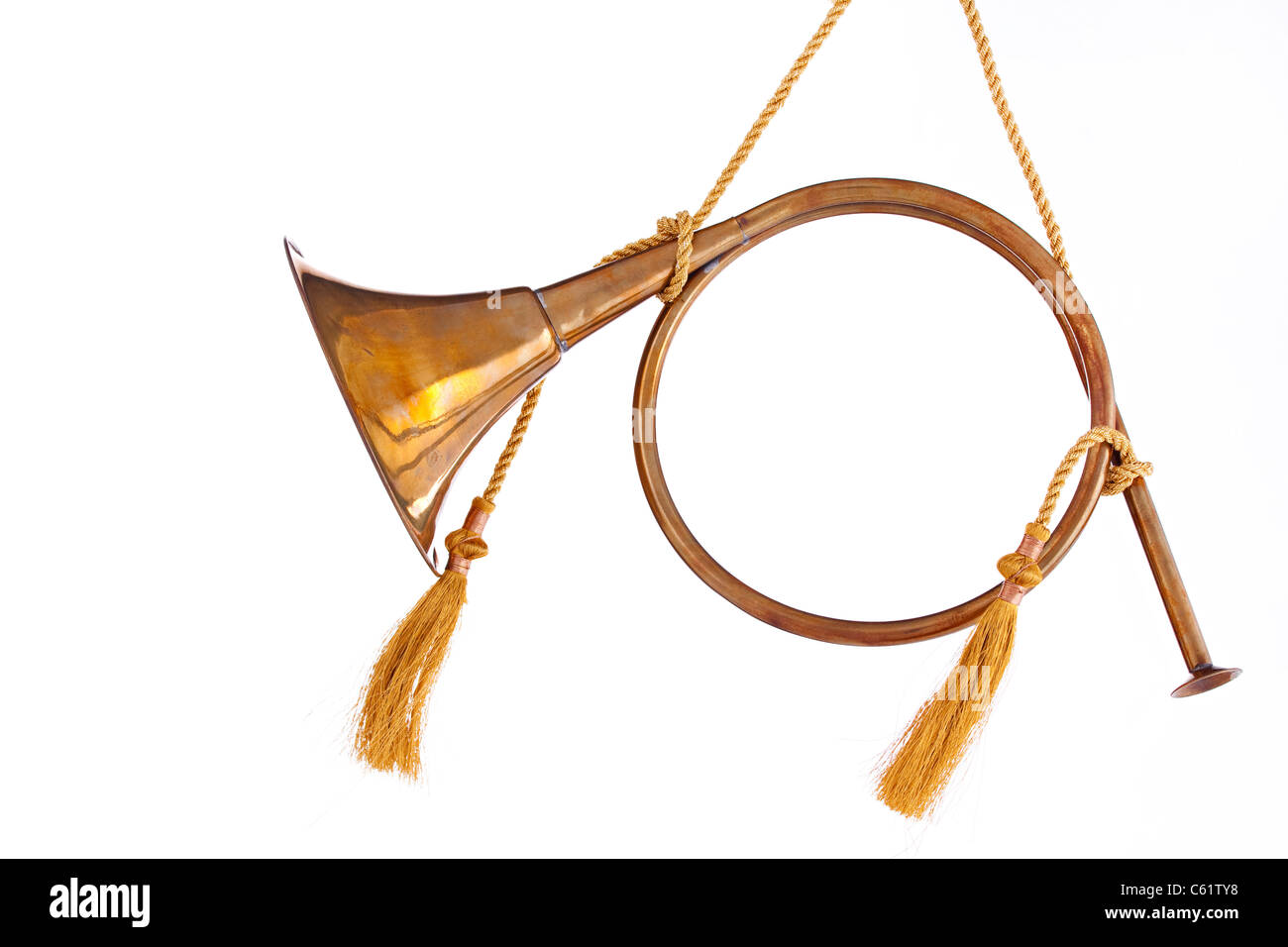 Un ornement de Noël couleur or laiton corne français isolé sur un fond blanc dans le format horizontal. Banque D'Images