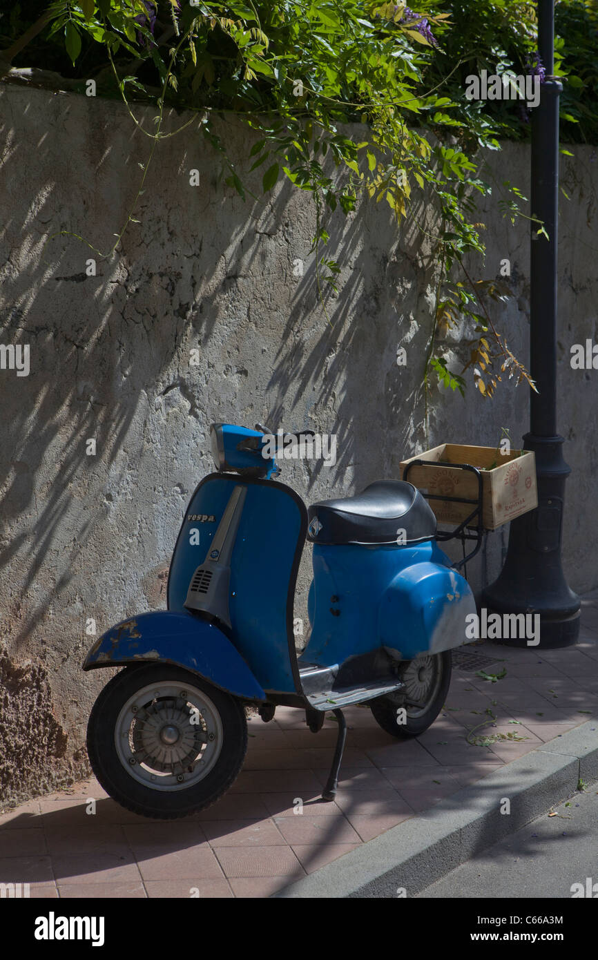 Scooter Vespa bleu Vintage garée quelque part en Sicile - côte méditerranéenne, l'Italie, l'Europe. Banque D'Images